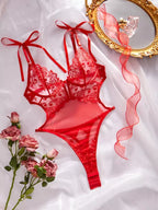Lingerie vermelha de renda com sutiã de laços e calcinha fio dental sensual feminina.