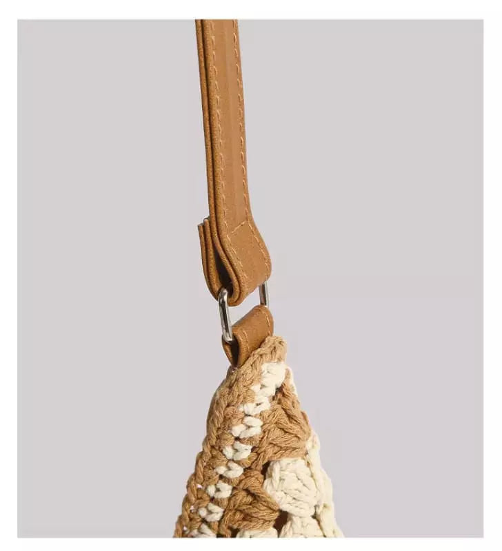 Alça de couro caramelo com costura contrastante e fixação em bolsa de crochê bege