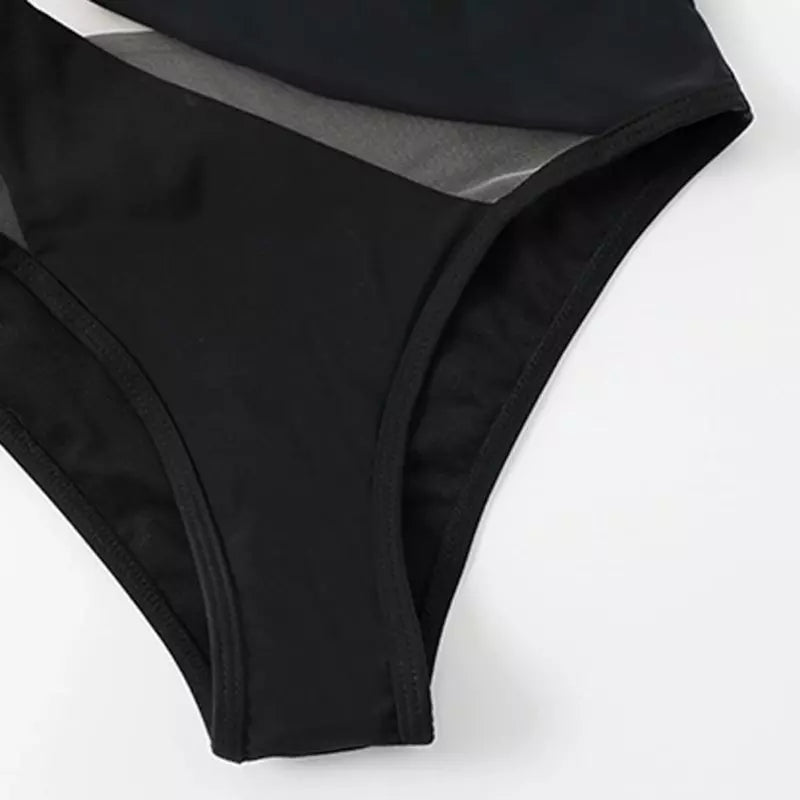 Detalhe calcinha biquíni preta com tule transparente, fundo branco, moda praia sofisticada.