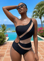 Maiô preto assimétrico com recortes, mulher de óculos em resort tropical com piscina e mar