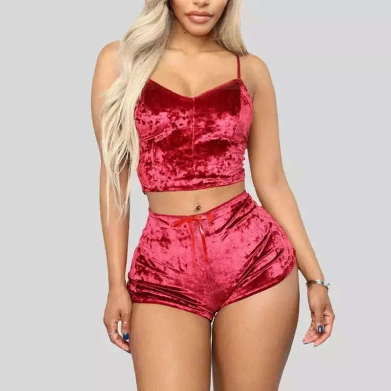 Conjunto de pijama em veludo vermelho, com top cropped de alças e shorts curto com laço, perfeito para noites confortáveis.