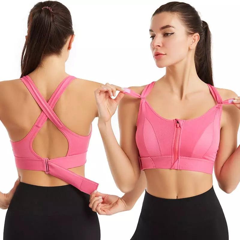 Top esportivo rosa com alças cruzadas nas costas, zíper frontal e ajuste por fivela, perfeito para fitness.
