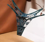 Calcinha fio dental verde azulada com renda floral e detalhes em tule transparente.